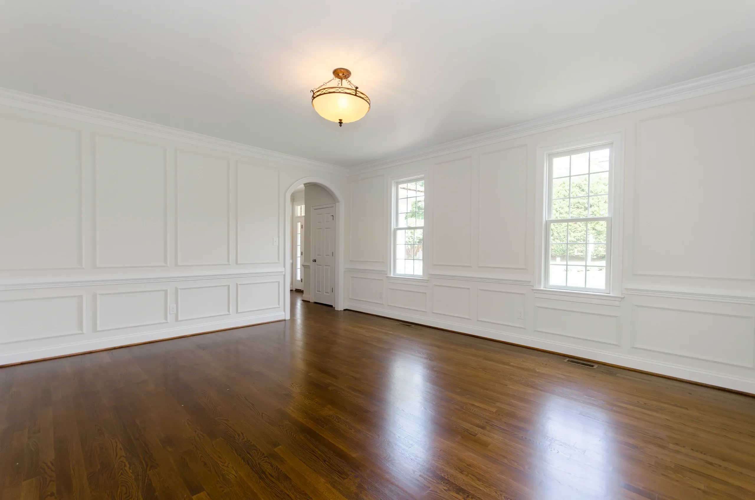 Formal room with dark stained hardwood floors and white wainscoting